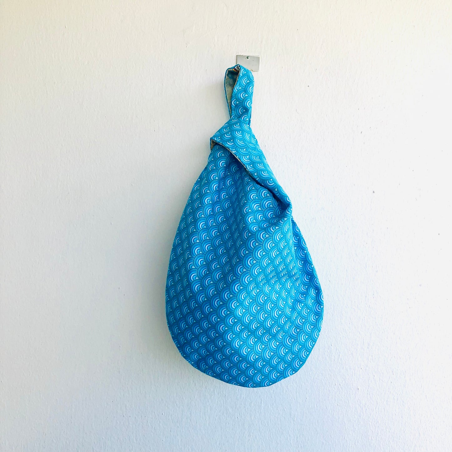 Cute small origami bag , handmade reversible knot bag , wrist fabric bag | Thin golden lines on a blue waves sea