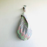 Small cute Japanese inspired knot bag , wrist origami bag , cool reversible fabric bag | Ladies wearing their coats in New York while they go up the Empire State Building