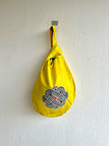 Origami knot bag, small Japanese inspired wrist bag , colorful African reversible bag | Amarillo Africa